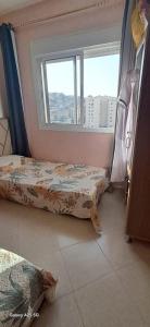 a bedroom with two beds and a window at Golf msnana in Tangier