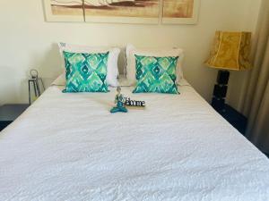 a doll sitting on top of a bed at City World Apartment in Maia