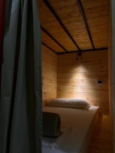 伏罗拉Queen-V Hostel的木床间的床,带窗帘