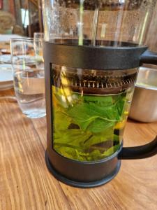 a blender filled with green vegetables on a table at Zemnieku saimniecība Paldaži in Limbaži