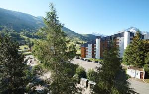 a view of a building with mountains in the background at Résidence Meijotel by Leavetown Vacations in Les Deux Alpes