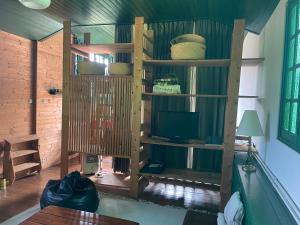a living room with a book shelf and a tv at l'atelier in Saint-Martin-des-Champs