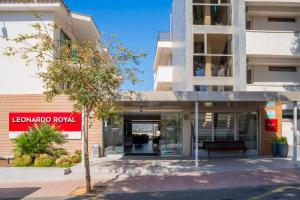 a building with a bench in front of it at Leonardo Royal Hotel Mallorca Palmanova Bay in Palmanova
