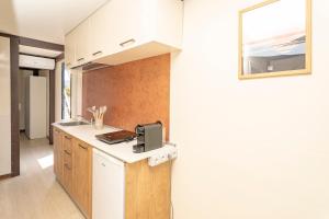 a kitchen with a sink and a microwave on a counter at Hoceanika Houseboat Porto Rotondo in Porto Rotondo