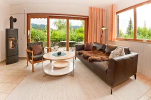 a living room with a couch and a table at Ferienhaus Fuchsweg im Feriendorf Reichenbach F8 in Nesselwang