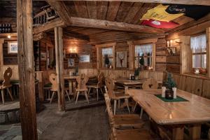 a dining room with wooden tables and chairs at Herzwies in Bad Hofgastein +59 photos