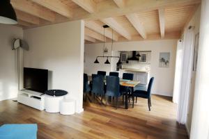a dining room and living room with a table and chairs at Kugelberg 13 in Heiligenhafen