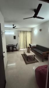 a living room with a couch and a table at Signature Gurgaon House 89 in Gurgaon