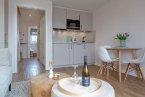 a living room with a bottle of wine on a table at Ferienwohnung Strandloft in Wenningstedt in Wenningstedt