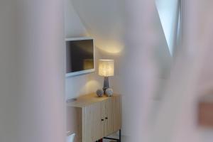 a lamp sitting on a table in a room at Ferienwohnung Strandloft in Wenningstedt in Wenningstedt