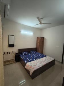 a bedroom with a bed and a ceiling at Signature Gurgaon House 89 in Gurgaon