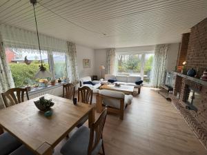 una sala de estar con una mesa y un sofá en Ferienhaus Janßen, en Esens