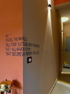 a room with a wall with a sign on the wall at Queen-V Hostel in Vlorë +15 photos