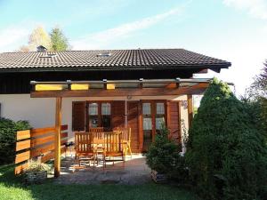 a house with a patio with a table and chairs at Ferienhaus Fuchsweg im Feriendorf Reichenbach F27b in Nesselwang
