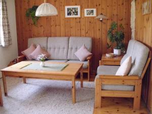 a living room with a couch and a coffee table at Ferienhaus Fuchsweg im Feriendorf Reichenbach F27b in Nesselwang +15 photos