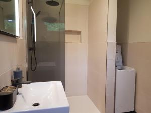 a white bathroom with a shower and a sink at Ferienhaus Max in Rerik