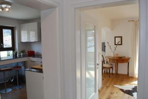 a kitchen and dining room with a table and a door at Zillibilly in Aschau im Chiemgau