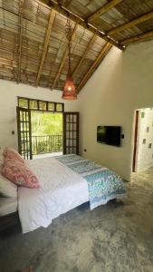 a bedroom with a large bed and a large window at Casa Atamari in Salento