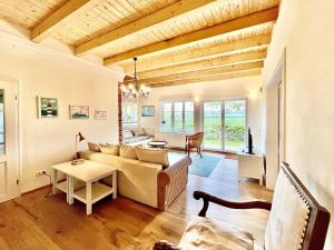 a living room with a couch and a table at Ferienwohnung im Gutsverwalterhaus Vieregge in Vieregge +14 photos