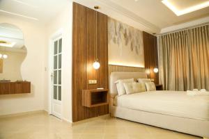 a bedroom with a bed with a wooden headboard at Residence Issrae 1 in Nador