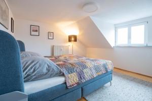 a bedroom with a bed with a blanket on it at Dohna, App 116 in Pirna