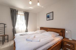 a bedroom with a large bed with white sheets at Ackerweg, App 03 in Ueckeritz +15 photos