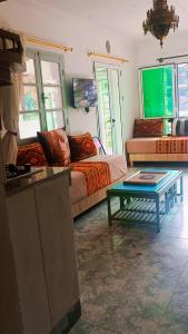a living room with a couch and a table at Riad SULTANA lateral seaview in Saïdia