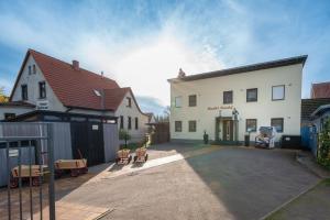 a large white building with a driveway in front of it at Knuddi s Ferienhof, App 04 in Zempin
