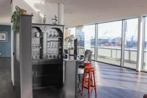 a restaurant with a bar with a view of the city at Penthouse-Appartement Diamant - ABC591 in Wismar