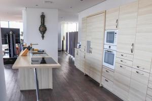 a kitchen with wooden cabinets and a counter top at Penthouse-Appartement Diamant - ABC591 in Wismar