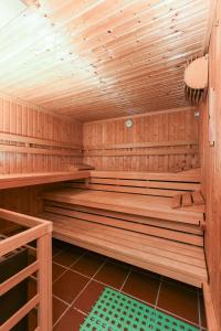 a wooden sauna with wooden benches in a room at Haus Bärensuite in Esens