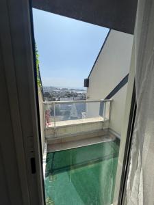 an empty balcony with a view of the water at Vue mer exceptionnelle-Appartement cosy à Erquy in Erquy