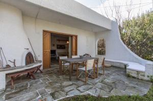 a patio with a table and chairs in a house at Jacuzzi Artistic Villa in Nea Makri in Nea Makri