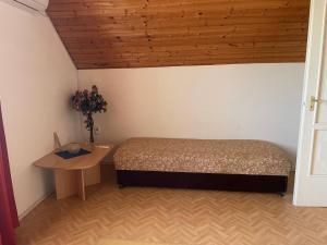 a bedroom with a bed and a wooden ceiling at VIL'LAGUNA Apartment with view of Balaton in Zánka +14 photos