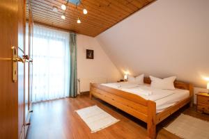 a bedroom with a bed and a large window at Ackerweg, App 02 in Ueckeritz