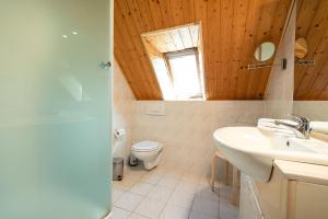 a bathroom with a sink and a toilet and a window at Ackerweg, App 02 in Ueckeritz +7 photos
