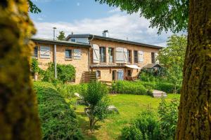 a large brick house with a garden in front of it at Das Backsteinhus, App Achtern Diek in Dargen