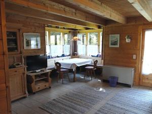 a dining room with a table and chairs in a room at Ferienhaus im Feriendorf Reichenbach B12a in Nesselwang +8 photos