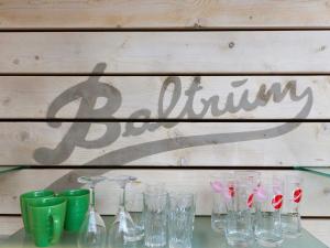 a group of glasses sitting on a glass table at Ferienwohnungen Hinrichs in Carolinensiel