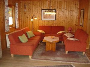 a living room with a couch and two chairs at Ferienhaus Fuchsweg im Feriendorf Reichenbach F23b in Nesselwang +7 photos