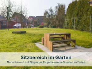 a picnic table and bench in a park at Stedesdorf, Ferienwohnung 'Nordsee-Wattwurm' in Stedesdorf