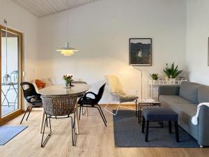 a living room with a couch and a table and chairs at Ferienhaus Gamssteige im Feriendorf Reichenbach G24a in Nesselwang