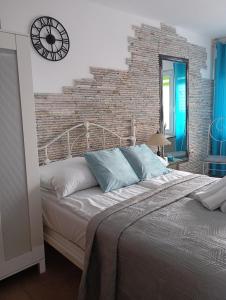 a bedroom with a large bed with a brick wall at K 2 in Jastrzębia Góra