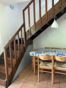 a dining room with a table and a staircase at Oleandro in Palazzo Vianello +5 photos