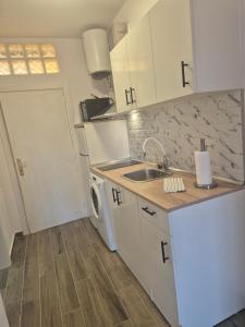 a small kitchen with a sink and a dishwasher at Juvica in Morro del Jable