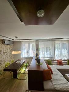 een woonkamer met een bank en een tafel bij Premium Apartment Vilsonovo in Sarajevo