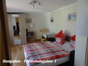 a bedroom with a bed and a living room at Ferienhaus Eppler _ Objekt 25845 in Rostock