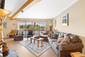 a living room with a couch and a table at Tahoe Keys Marina View - 3 BDR Desirable Community in South Lake Tahoe