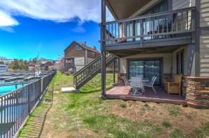 a deck with a table and chairs next to a house at Tahoe Keys Marina View - 3 BDR Desirable Community in South Lake Tahoe