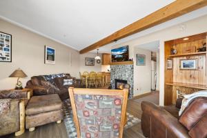 a living room with leather furniture and a fireplace at Tahoe Keys Marina View - 3 BDR Desirable Community in South Lake Tahoe